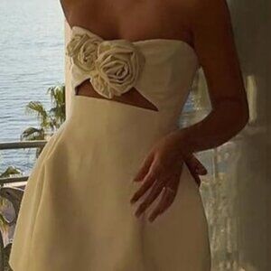 White mini dress with cutouts and rosettes